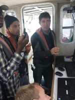 Ian Church and three students operating computers to map the seabed.