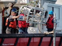 Photograph of Fisheries and Oceans Canada scientists deploying a drop camera system from the ‘Viola Davidson’.